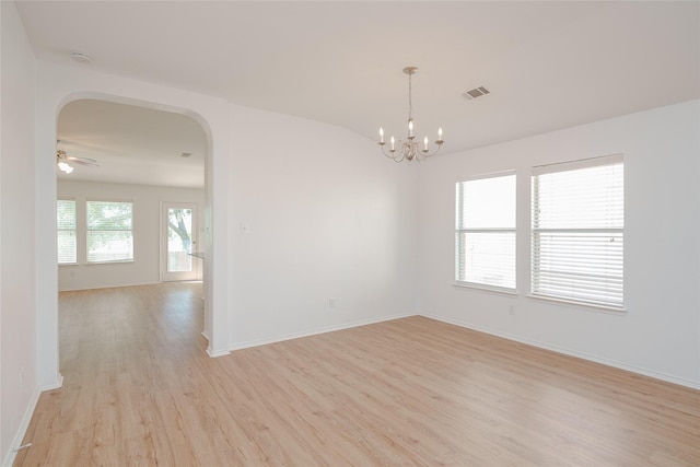 2912 Lighthouse Dr, Denton, TX 76210 - spare room with arched walkways, light wood-style floors, a chandelier, a smoke detector, and vaulted ceiling