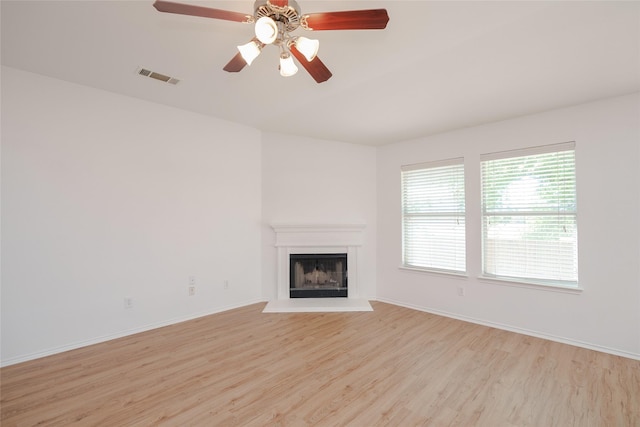 2912 Lighthouse Dr, Denton, TX 76210 - unfurnished living room with light wood finished floors, a fireplace with raised hearth, and ceiling fan