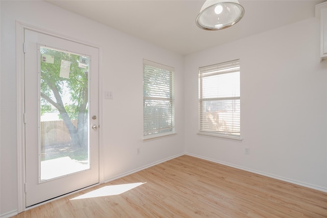 2912 Lighthouse Dr, Denton, TX 76210 - doorway to outside with light wood-style flooring and baseboards