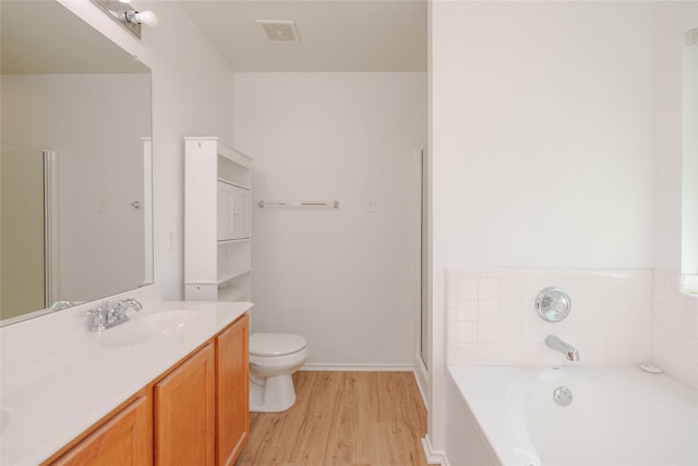 2912 Lighthouse Dr, Denton, TX 76210 - bathroom featuring a garden tub, wood finished floors, double vanity, and a shower with door