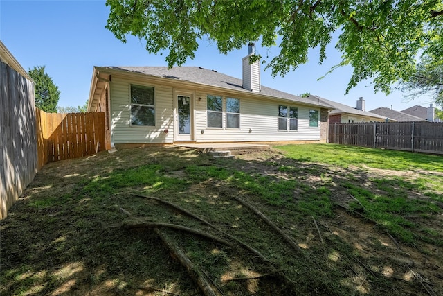2912 Lighthouse Dr, Denton, TX 76210 - rear view of house with a fenced backyard and a chimney
