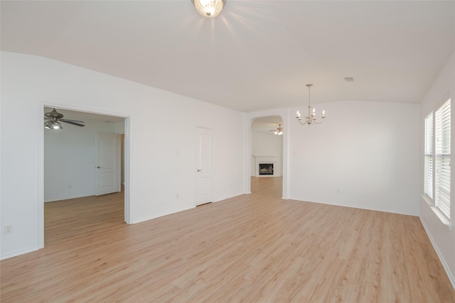 2912 Lighthouse Dr, Denton, TX 76210 - unfurnished room featuring lofted ceiling, ceiling fan, a chandelier, and light wood-type flooring