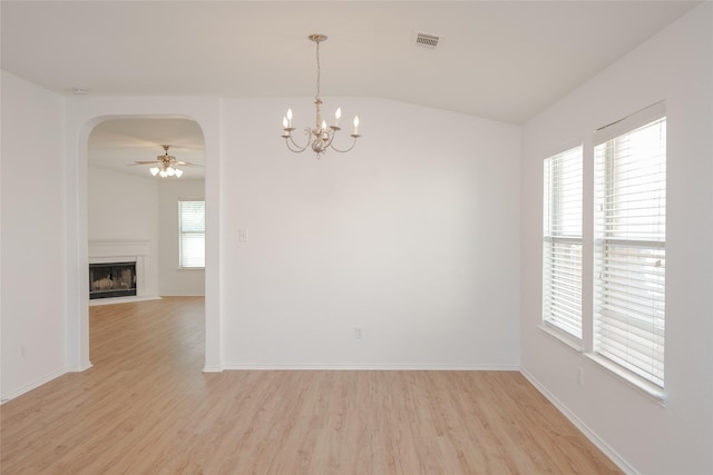 2912 Lighthouse Dr, Denton, TX 76210 - unfurnished room featuring arched walkways, light wood finished floors, ceiling fan, a chandelier, and a fireplace with flush hearth