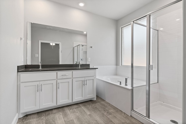 724 Cromane Rd, Fort Worth, TX 76052 - full bath with double vanity, a shower stall, a bath, wood finished floors, and recessed lighting