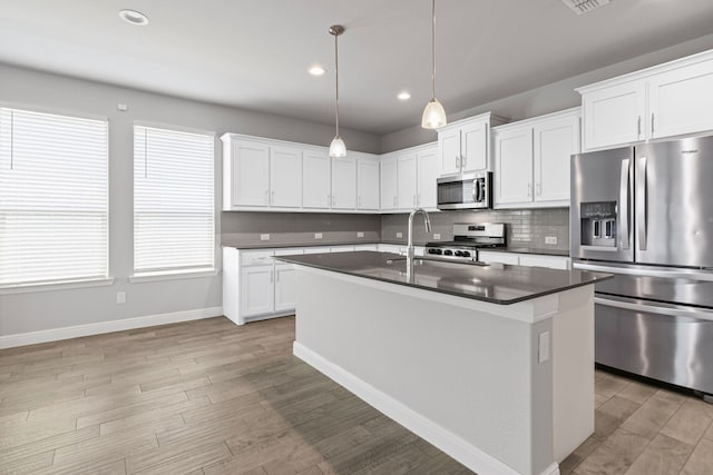 724 Cromane Rd, Fort Worth, TX 76052 - kitchen featuring appliances with stainless steel finishes, dark countertops, tasteful backsplash, light wood-style flooring, and recessed lighting