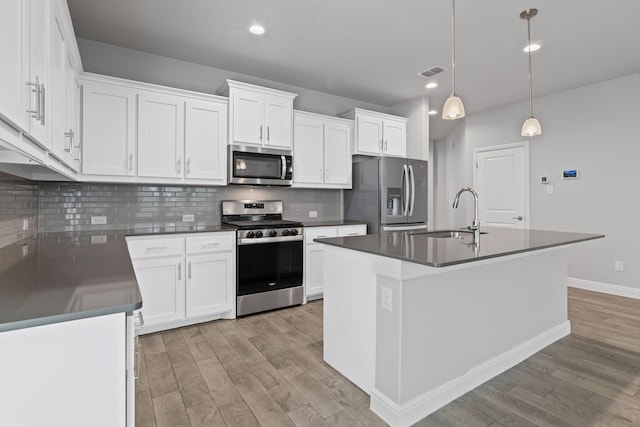 724 Cromane Rd, Fort Worth, TX 76052 - kitchen with stainless steel appliances, light wood-style flooring, dark countertops, decorative backsplash, and recessed lighting