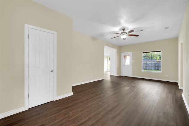 1724 Lincolnshire Way, Fort Worth, TX 76134 - unfurnished living room featuring a ceiling fan and dark wood-type flooring