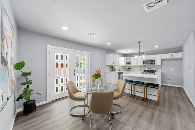 2473 W Five Mile Pkwy, Dallas, TX 75233 - dining space with light wood-style floors, recessed lighting, and french doors