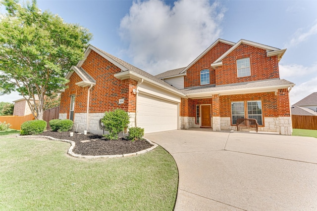 1684 Tannerson Dr, Rockwall, TX 75087 - traditional home featuring a porch, concrete driveway, stone siding, an attached garage, and brick siding