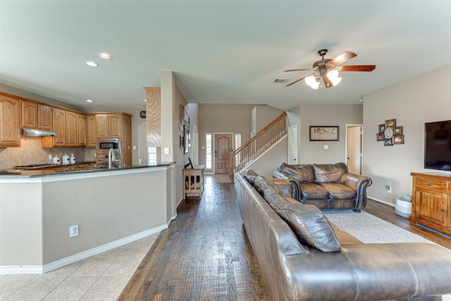 1684 Tannerson Dr, Rockwall, TX 75087 - living area featuring a ceiling fan, recessed lighting, and stairs