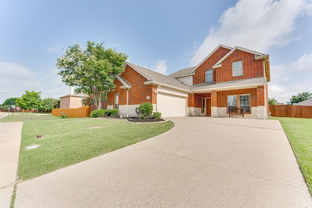 1684 Tannerson Dr, Rockwall, TX 75087 - view of front of house featuring stone siding, a garage, concrete driveway, brick siding, and covered porch