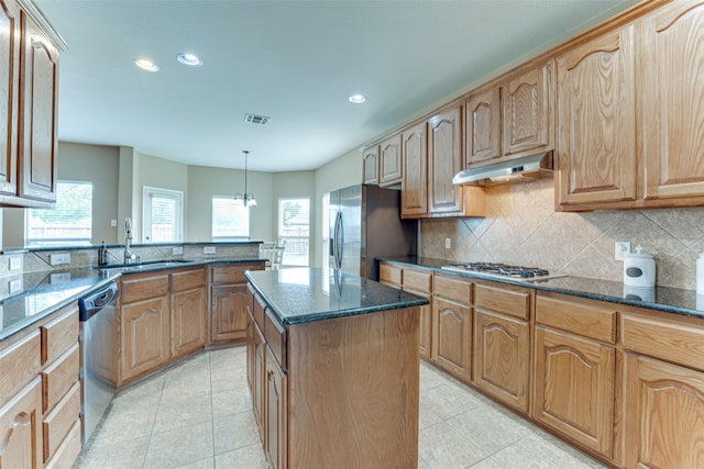 1684 Tannerson Dr, Rockwall, TX 75087 - kitchen with under cabinet range hood, stainless steel appliances, recessed lighting, tasteful backsplash, and dark stone countertops