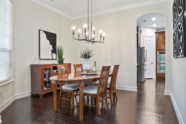 2542 Morgan Ln, Trophy Club, TX 76262 - dining space featuring arched walkways, dark wood finished floors, a chandelier, and ornamental molding