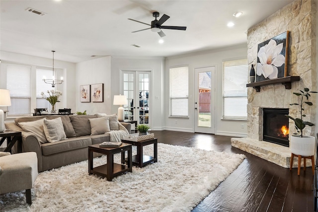 2542 Morgan Ln, Trophy Club, TX 76262 - living area featuring dark wood-style flooring, ceiling fan, a fireplace, a chandelier, and crown molding