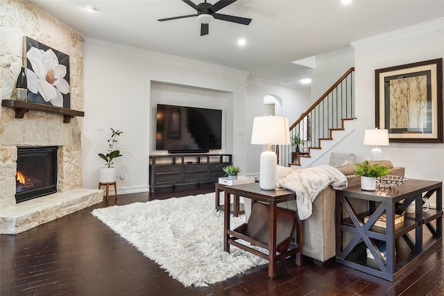 2542 Morgan Ln, Trophy Club, TX 76262 - living room featuring crown molding, ceiling fan, dark wood-style flooring, stairs, and a fireplace