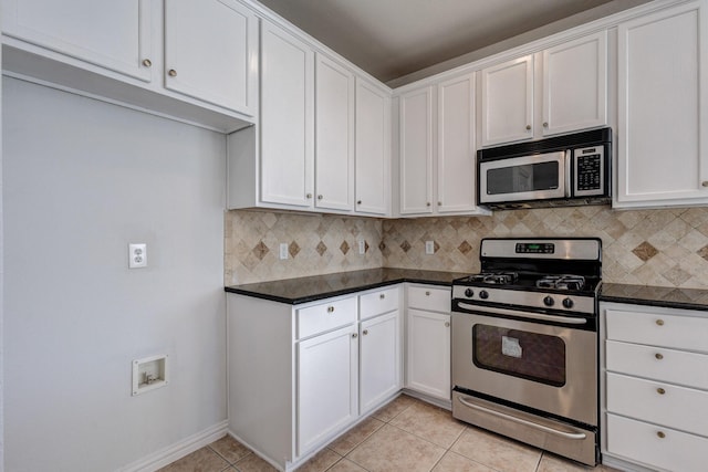 7101 Bickers Dr, Rowlett, TX 75089 - kitchen featuring stainless steel appliances, backsplash, dark countertops, white cabinets, and light tile patterned floors