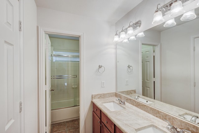 7101 Bickers Dr, Rowlett, TX 75089 - bathroom featuring double vanity, bath / shower combo with glass door, and tile patterned flooring