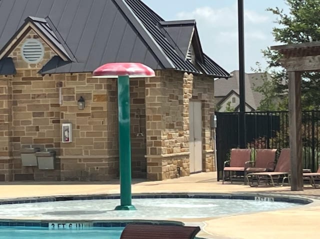 2332 Evening Stone Dr, Little Elm, TX 76227 - exterior space featuring stone siding and a jacuzzi