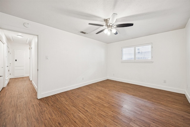 2529 W 12th St, Dallas, TX 75211 - empty room featuring a ceiling fan, wood finished floors, a smoke detector, and attic access
