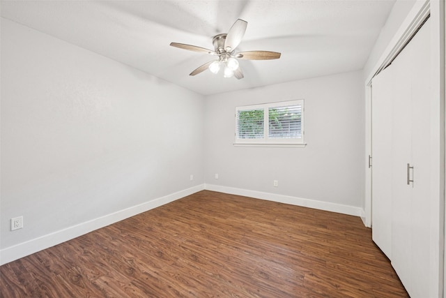 2529 W 12th St, Dallas, TX 75211 - unfurnished bedroom with dark wood finished floors, a ceiling fan, and a closet