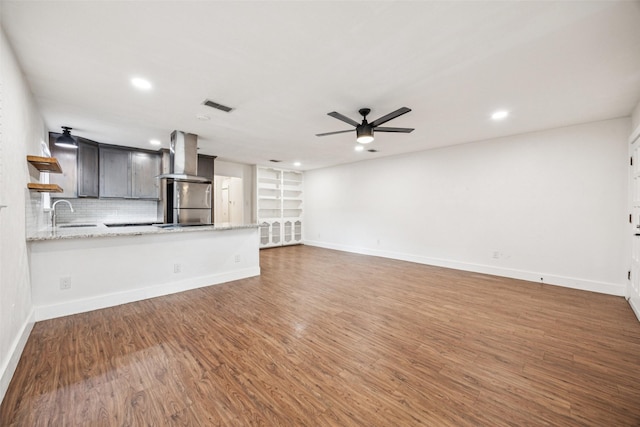 2529 W 12th St, Dallas, TX 75211 - unfurnished living room featuring a ceiling fan, wood finished floors, and recessed lighting