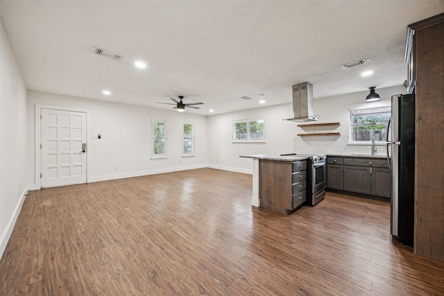 2529 W 12th St, Dallas, TX 75211 - kitchen featuring stainless steel appliances, ceiling fan, island range hood, recessed lighting, and wood finished floors
