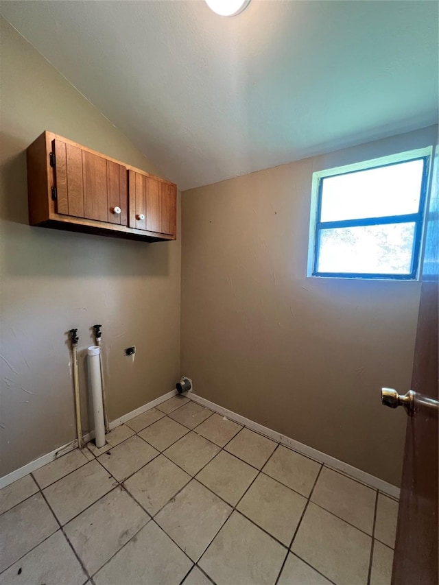 717 N 37th St, Corsicana, TX 75110 - laundry area with cabinet space, light tile patterned floors, and washer hookup