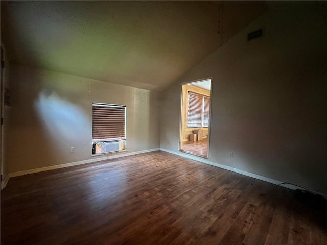 717 N 37th St, Corsicana, TX 75110 - unfurnished room featuring dark wood-style floors, lofted ceiling, and cooling unit