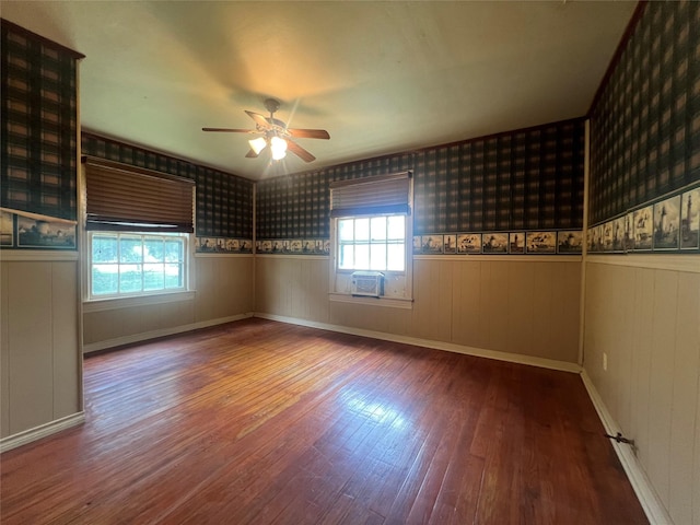 717 N 37th St, Corsicana, TX 75110 - spare room featuring wood finished floors, a ceiling fan, wainscoting, wallpapered walls, and cooling unit