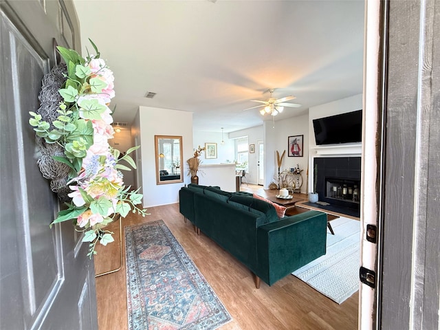 3541 Cripple Creek Trl, Fort Worth, TX 76262 - living room featuring wood finished floors, a tile fireplace, and ceiling fan