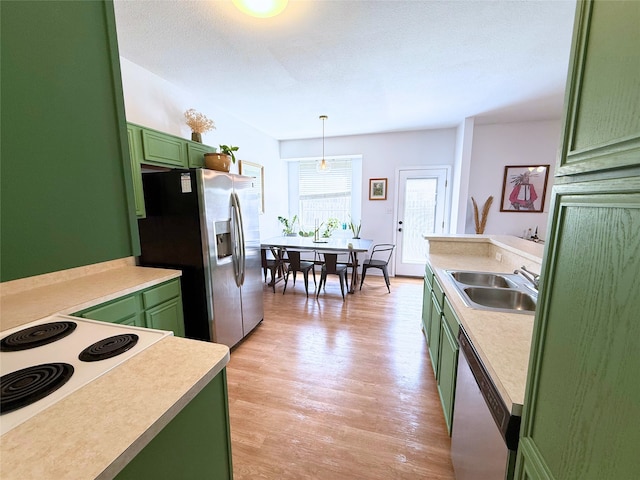 3541 Cripple Creek Trl, Fort Worth, TX 76262 - kitchen featuring green cabinets, stainless steel appliances, light wood finished floors, and light countertops