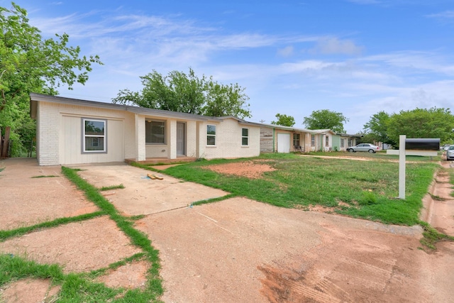 5274 Questa Dr, Abilene, TX 79605 - view of front of property featuring brick siding, a front lawn, and driveway