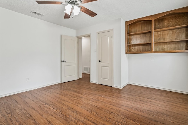 2526 Axminster Dr, Grand Prairie, TX 75050 - empty room with ceiling fan, wood finished floors, and a textured ceiling