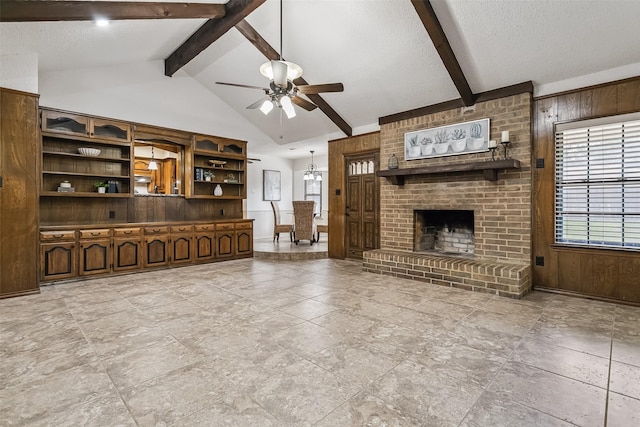 2526 Axminster Dr, Grand Prairie, TX 75050 - unfurnished living room featuring ceiling fan, plenty of natural light, wooden walls, a brick fireplace, and a textured ceiling