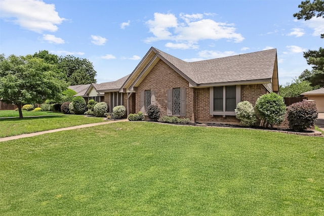 2526 Axminster Dr, Grand Prairie, TX 75050 - ranch-style house with brick siding, a shingled roof, and a front lawn