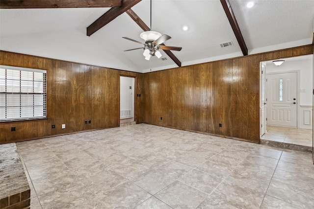 2526 Axminster Dr, Grand Prairie, TX 75050 - unfurnished living room with wood walls, a ceiling fan, and a textured ceiling