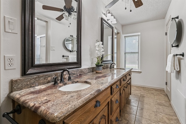 2526 Axminster Dr, Grand Prairie, TX 75050 - bathroom with a ceiling fan, a textured ceiling, and double vanity