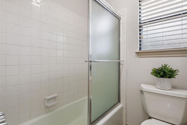 2526 Axminster Dr, Grand Prairie, TX 75050 - bathroom featuring bath / shower combo with glass door and toilet