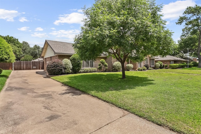 2526 Axminster Dr, Grand Prairie, TX 75050 - view of property hidden behind natural elements featuring brick siding and driveway