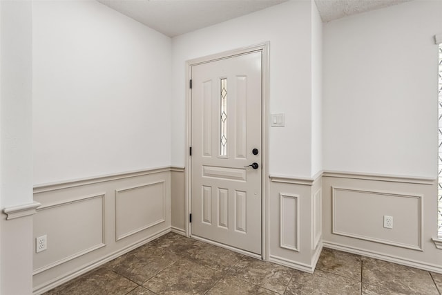 2526 Axminster Dr, Grand Prairie, TX 75050 - foyer entrance featuring a decorative wall and a wainscoted wall