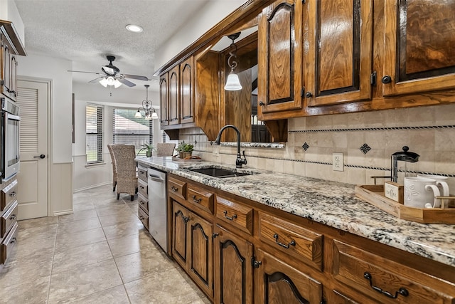 2526 Axminster Dr, Grand Prairie, TX 75050 - kitchen with ceiling fan, stainless steel dishwasher, tasteful backsplash, a textured ceiling, and hanging light fixtures