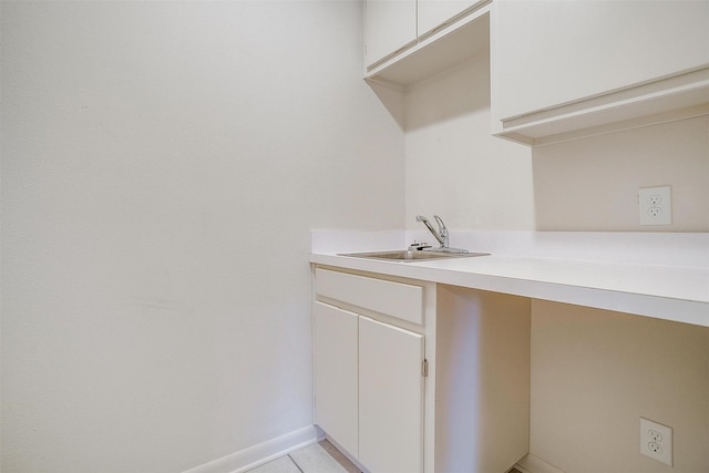 302 S Fox Ln, Burleson, TX 76028 - laundry room featuring a sink and light tile patterned floors
