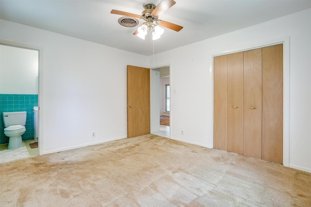 302 S Fox Ln, Burleson, TX 76028 - unfurnished bedroom featuring carpet, ensuite bath, a closet, and a ceiling fan