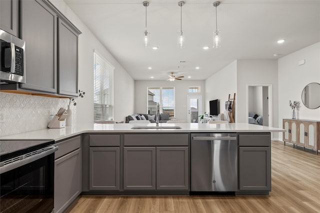 3401 Beutel Rd, Lorena, TX 76655 - kitchen featuring stainless steel appliances, gray cabinets, recessed lighting, and tasteful backsplash
