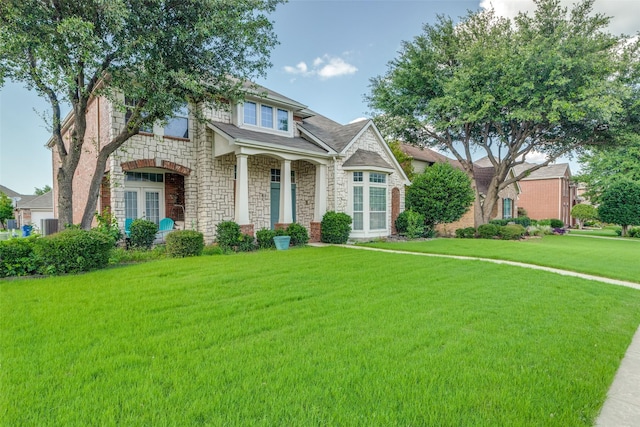 11398 Pear Ridge Dr, Frisco, TX 75035 - view of front of house with stone siding, a front lawn, and french doors