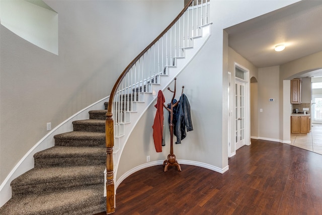 11398 Pear Ridge Dr, Frisco, TX 75035 - stairway featuring arched walkways and wood finished floors