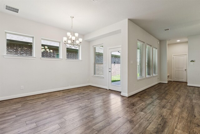 905 Plaza Ln, Argyle, TX 76226 - empty room with wood finished floors and a chandelier