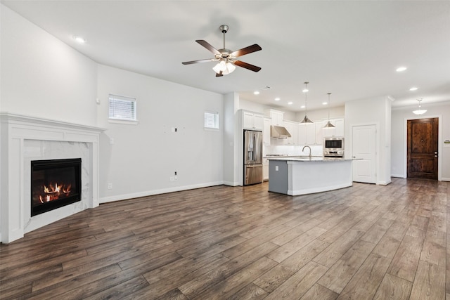 905 Plaza Ln, Argyle, TX 76226 - unfurnished living room featuring ceiling fan, dark wood-style floors, recessed lighting, and a fireplace