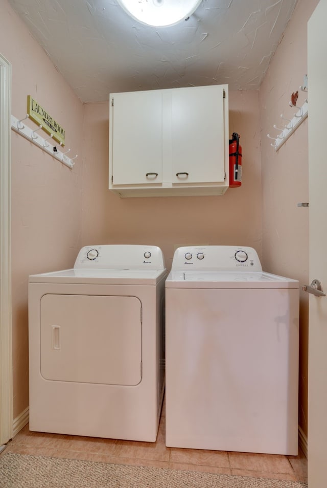 2086 Breezywood Dr, Flower Mound, TX 75022 - laundry room with cabinet space, washing machine and dryer, and light tile patterned floors
