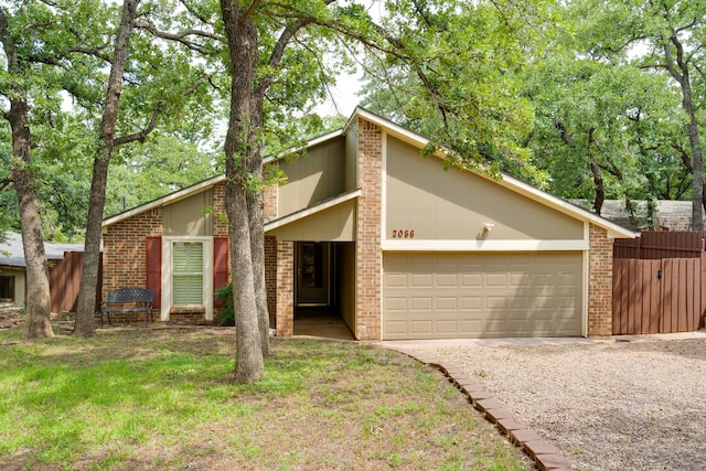 2086 Breezywood Dr, Flower Mound, TX 75022 - mid-century modern home with an attached garage, driveway, and brick siding